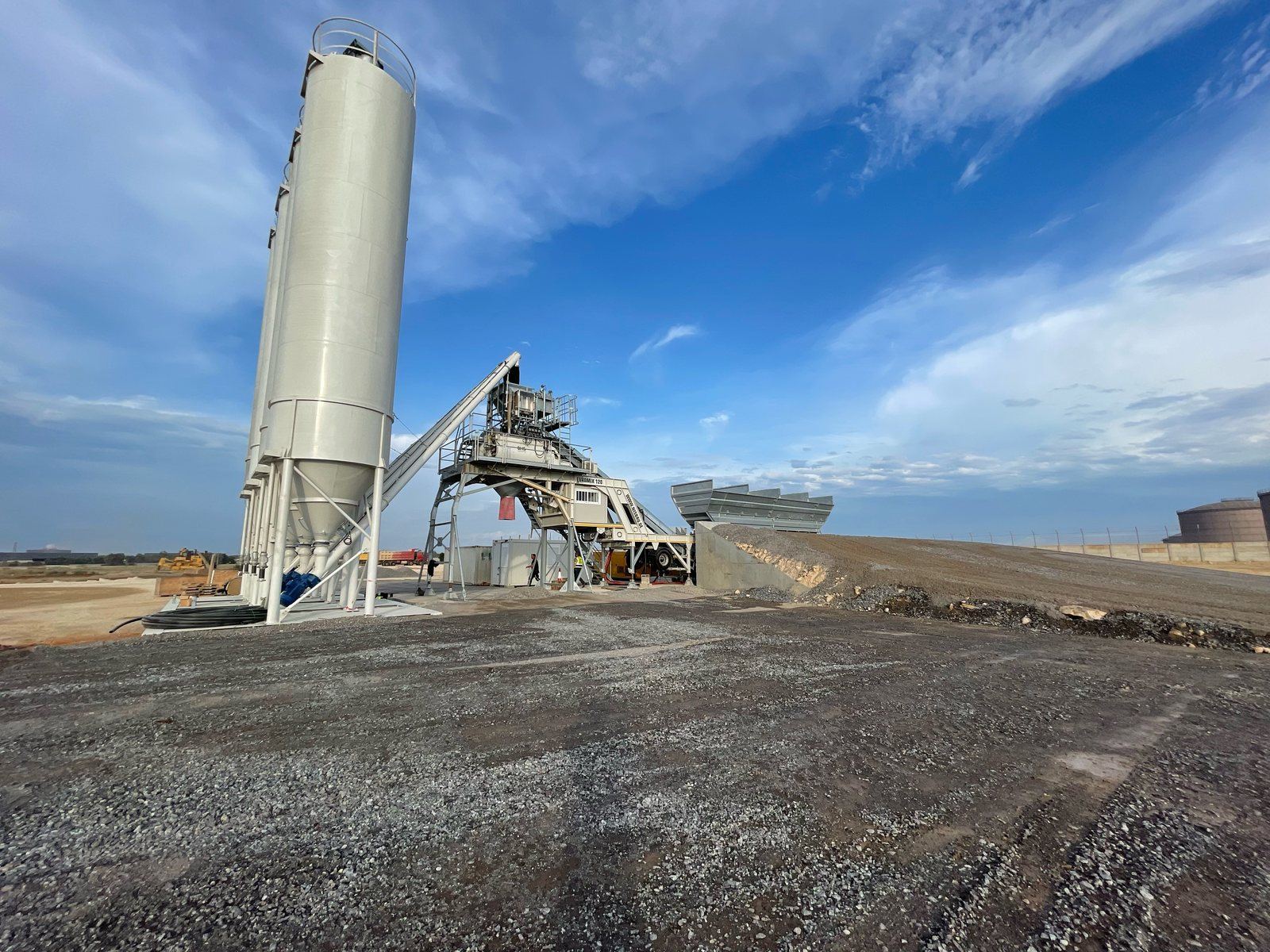 A NISBAU EUROMIX 120 wheel-mobile concrete mixing plant on site in Angola