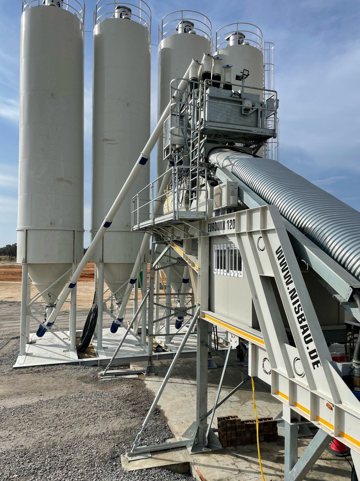 A NISBAU EUROMIX 120 plant with its aggregate chassis on site in Angola
