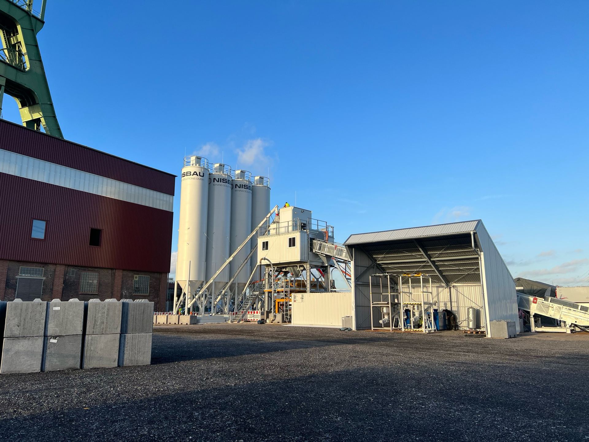 A NISBAU Mining Solutions shaft filling plant with cement silos at a mine shaft in Germany