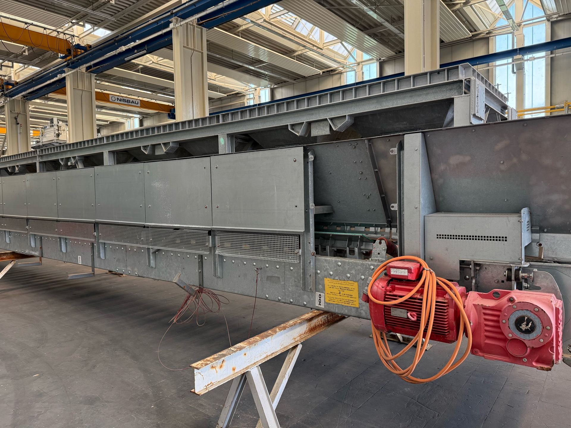 A galvanized weighing and dosing conveyor module in the NISBAU assembly hall